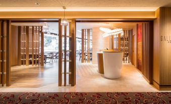 a modern restaurant with wooden chairs and tables , a white reception desk , and an abstract art piece on the wall at Sheraton Grande Tokyo Bay Hotel