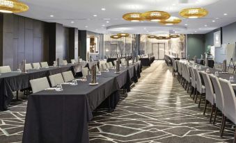a large conference room with multiple tables and chairs arranged for a meeting or event at Mercure Melbourne Caroline Springs
