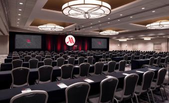 a large conference room with rows of chairs arranged in a semicircle , and a podium at the front of the room at Portland Marriott Downtown Waterfront