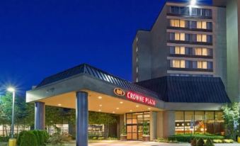 "a hotel entrance with a sign that reads "" crowne plaza "" prominently displayed on the building" at Crowne Plaza Englewood, an IHG Hotel