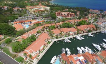 aerial view of a large resort with multiple buildings , marina , and boats docked in the water at Park Royal Homestay Club Cala Puerto Rico