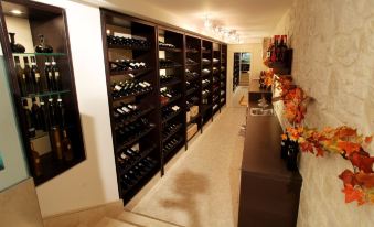a wine cellar filled with numerous bottles of wine on shelves , creating an inviting atmosphere at Hotel Cenacolo