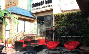 "a brick building with a sign that reads "" cheater bar "" prominently displayed on the front of the building" at Hotel Shangri la