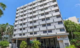 "a tall white building on a city street , with a sign that reads "" avd ""." at Argus Hotel Darwin