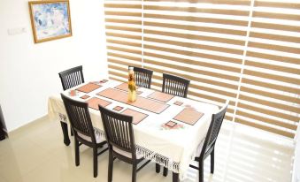 a dining table with a white tablecloth and six chairs , set for six people to enjoy a meal together at Click to Go