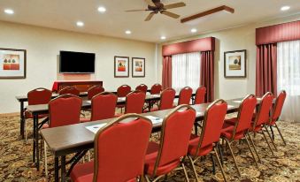 a large conference room with multiple rows of chairs arranged in a semicircle around a long table at Country Inn & Suites by Radisson, Rock Falls, IL