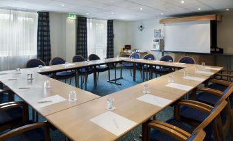 a conference room with a large table surrounded by chairs , water bottles , and papers on the tables at Holiday Inn Express Newcastle Gateshead