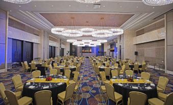 a large banquet hall with tables and chairs set up for a formal event , possibly a wedding reception at bai Hotel Cebu