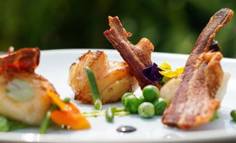 a plate of food on a dining table , with a variety of dishes and ingredients at The Fishbourne