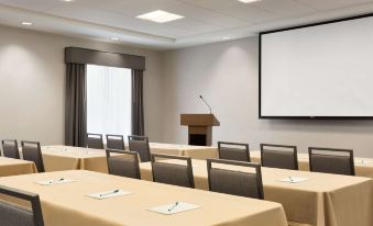 a conference room with rows of chairs arranged in a semicircle , and a podium at the front of the room at Homewood Suites by Hilton Salt Lake City Draper