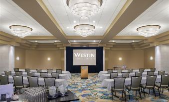 a conference room with rows of chairs arranged in a semicircle , and a large screen on the wall at The Westin St. John Resort Villas