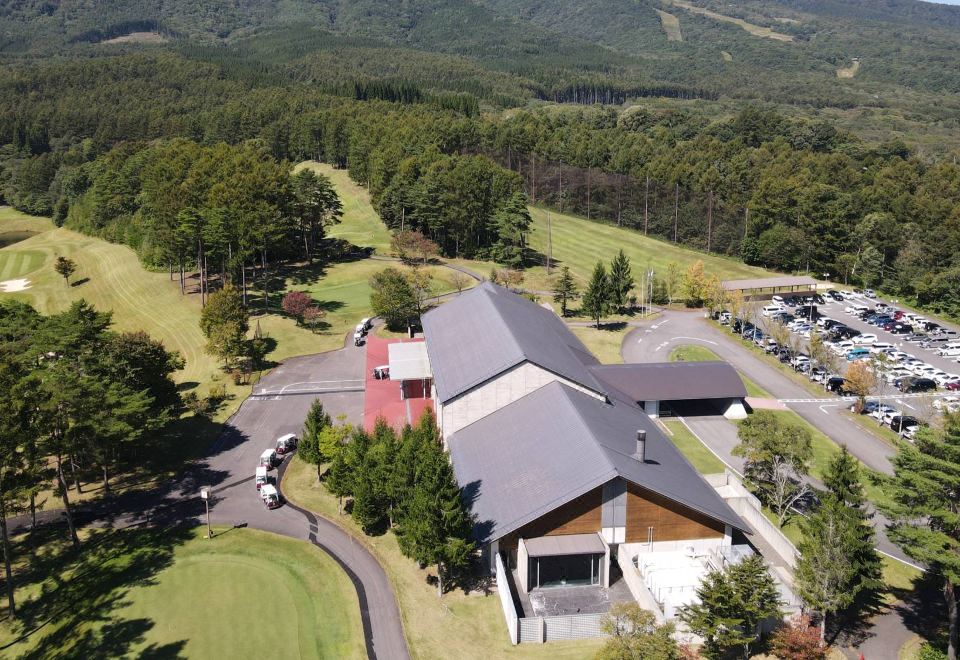 aerial view of a golf course with a building in the background and a golf course in the foreground at Arcadia