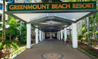 "a hotel entrance with a sign that reads "" greenmount beach resort "" above it , indicating that the hotel has a" at Greenmount Beach House