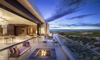 a modern apartment with a rooftop patio , where a fire pit is set up for relaxation at Nobu Hotel Los Cabos