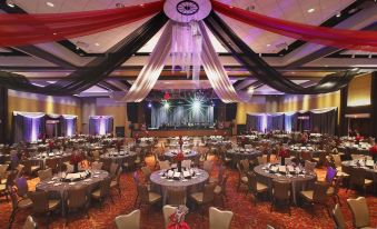 a large banquet hall with multiple dining tables and chairs set up for a formal event at Four Winds Casino Resort – New Buffalo