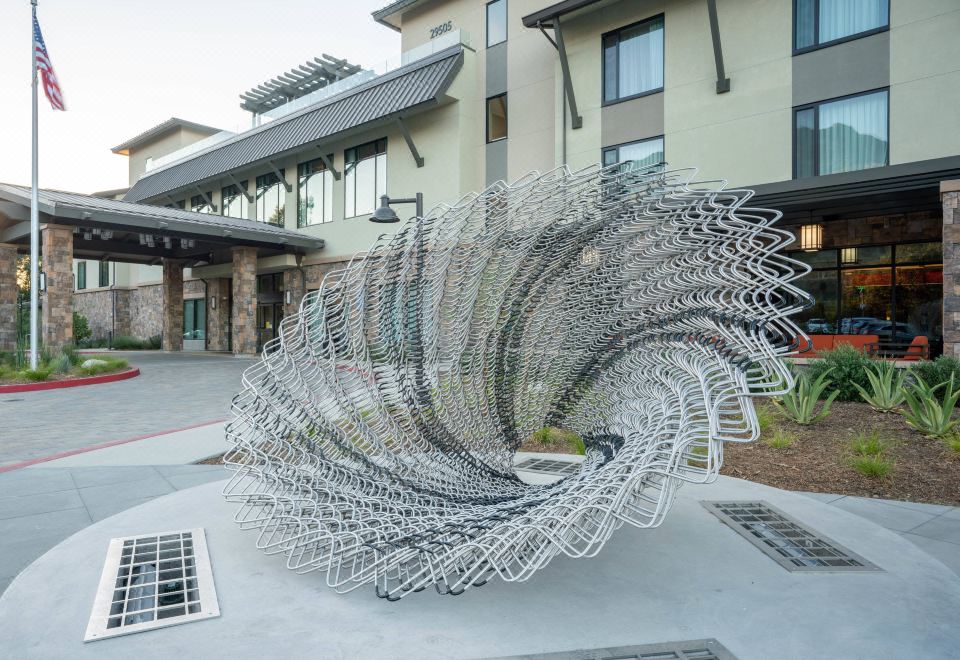 a large , modern sculpture made of metal , situated in front of a building with a modern design at Courtyard Thousand Oaks Agoura Hills