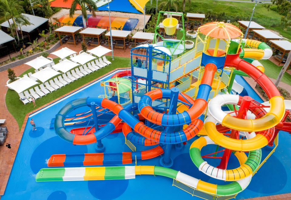 an aerial view of a colorful water park with multiple slides , fountains , and play structures for children to enjoy at Big4 Gold Coast Holiday Park