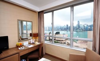 The room is equipped with large windows that overlook the city and an office space in the front at The Salisbury YMCA of Hong Kong