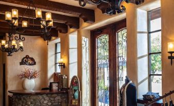 a modern , well - lit interior with wooden beams , stone walls , and large windows , as well as a clothing store containing various items on at Tubac Golf Resort & Spa