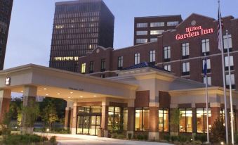 the exterior of a hilton garden inn hotel at night , with its large building and surrounding trees at Hilton Garden Inn Bartlesville