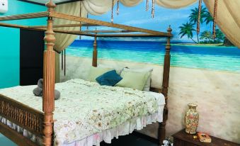 a cozy bedroom with a large canopy bed , decorated with tropical - themed bedding and pillows , and a mural of a beach scene on the wall at Bantayan Island Nature Park and Resort