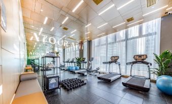 The gym in the middle has large windows that provide ample natural light, creating a well-lit indoor space at Atour Hotel (Shenzhen Nanshan Vanke Yuncheng)