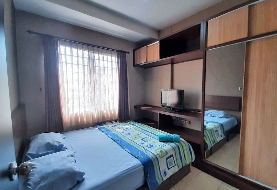 a hotel room with two beds , one on the left and one on the right side of the room at High Livin Apartment Baros