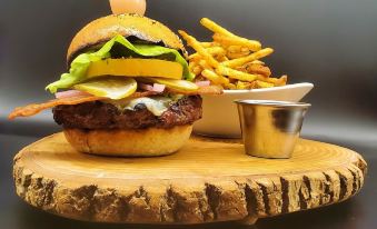 a wooden table with a plate of fries and a hamburger on top of a wooden board at Inn at the Falls