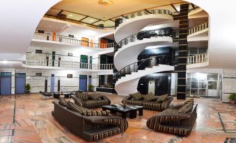 a large hotel lobby with multiple couches , chairs , and tables arranged in an inviting manner at Hotel President