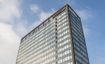 "a modern office building with a glass facade and the word "" moxiano "" on its top" at Hampton by Hilton Birmingham Broad Street