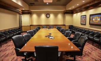 a large conference room with a long wooden table and several chairs arranged around it at Four Winds Casino Resort – New Buffalo