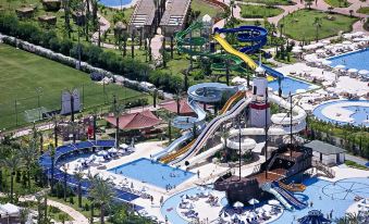 aerial view of a water park with multiple slides , pools , and play areas for children at Titanic Deluxe Lara