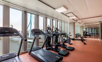 a well - equipped gym with various exercise equipment , such as treadmills , stationary bikes , and weight machines at Nhow Rotterdam