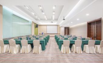 A spacious ballroom at the hotel is arranged with tables and chairs for a wedding at Holiday Inn Express Beijing Dongzhimen
