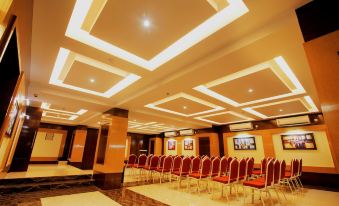 a large conference room with rows of red chairs arranged in a semicircle around a long table at Imperial Heights