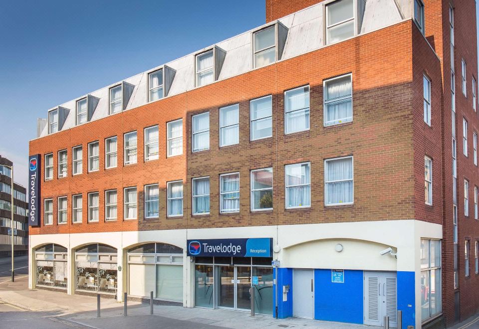 "a brick building with a blue sign that reads "" travelodge "" is shown on a street" at Travelodge Norwich Central Riverside