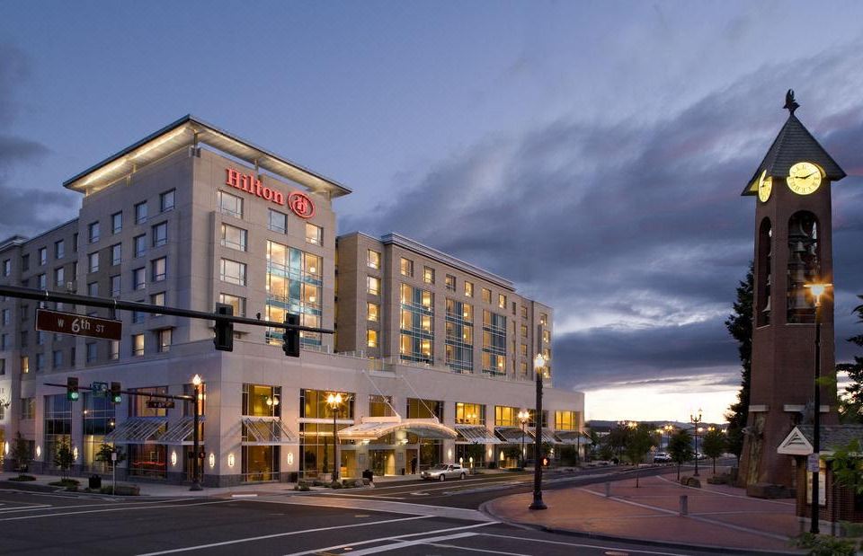 "a large hotel building with a sign that says "" hilton "" on the front and a street in front of it" at Hilton Vancouver Washington
