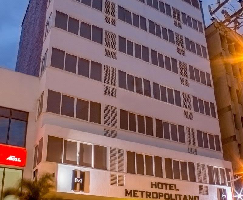 a tall building with a hotel sign on the side , located in a city setting at Hotel Metropolitano