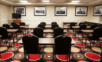 a conference room with several tables and chairs arranged for a meeting or training session at Hampton Inn Moultrie