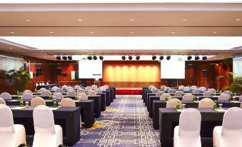A spacious ballroom with tables and chairs arranged for an event at Novotel Beijing Peace
