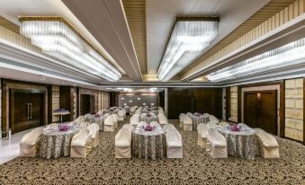 a large , elegant banquet hall with multiple round tables and chairs set up for a formal event at The Regenza by Tunga