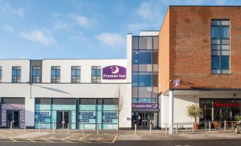 "a modern building with the name "" premier inn "" on it , and a sign in front of the entrance" at Premier Inn Trowbridge