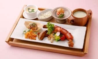 a white plate with a variety of food items on it , including meat , vegetables , and soup at Okuhita Onsen Umehibiki