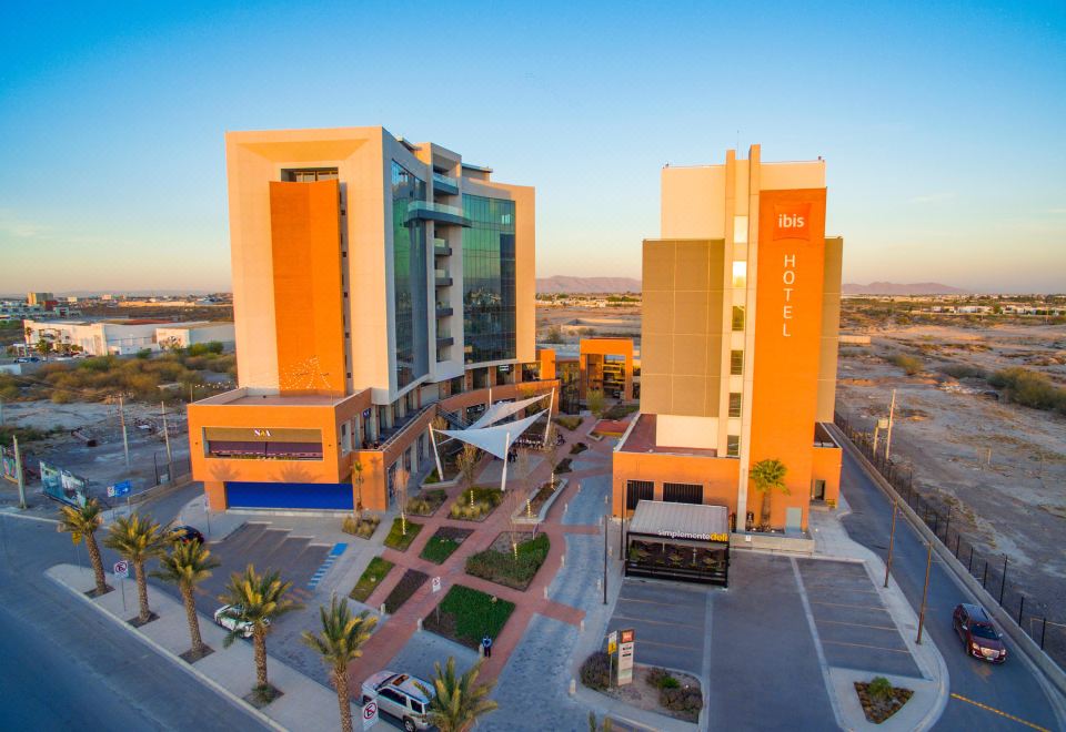 a large building with two tall buildings , one on the left side and the other on the right side of the building at Ibis Torreon