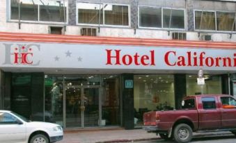 "a hotel building with a red and white sign that says "" hotel california "" on it" at Hotel California