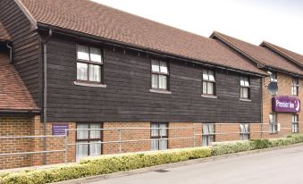 a large brick building with multiple windows and a sign on the side of the building at Sandhurst