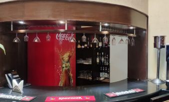 a bar with a coca - cola advertisement on the wall and a variety of bottles in the background at The Richmond