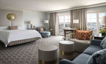 a hotel room with a king - sized bed , a couch , and a coffee table in the corner at The Ritz-Carlton, Marina del Rey