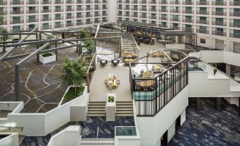 a modern , open - air atrium with multiple levels and balconies , providing a pleasant outdoor space for relaxation and entertainment at Hyatt Regency San Francisco Airport