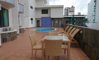 a rooftop patio with a pool , chairs , and tables set up for outdoor dining or relaxation at Hotel Principe